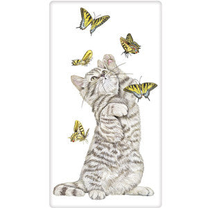 Grey and white striped kitten playing with 5 yellow butterflies that are in flight.