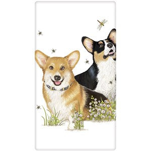 Tri color Corgis sitting in flowers watching bees and dragonfly.