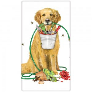 Golden Retriever with garden hose in mouth and holding tool pale in mouth with garden tools. Has broken flower pot at feet.