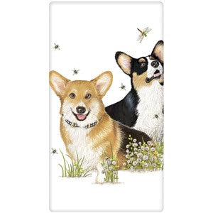 Tri color Corgis sitting in flowers watching bees and dragonfly.  