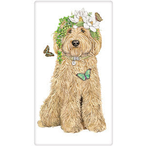 Tan Golden Doodle full body sitting with floral crown and three butterflies fluttering around dogs face.  