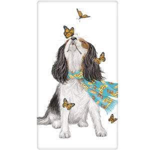 spaniel puppy looking at butterflies with scarf